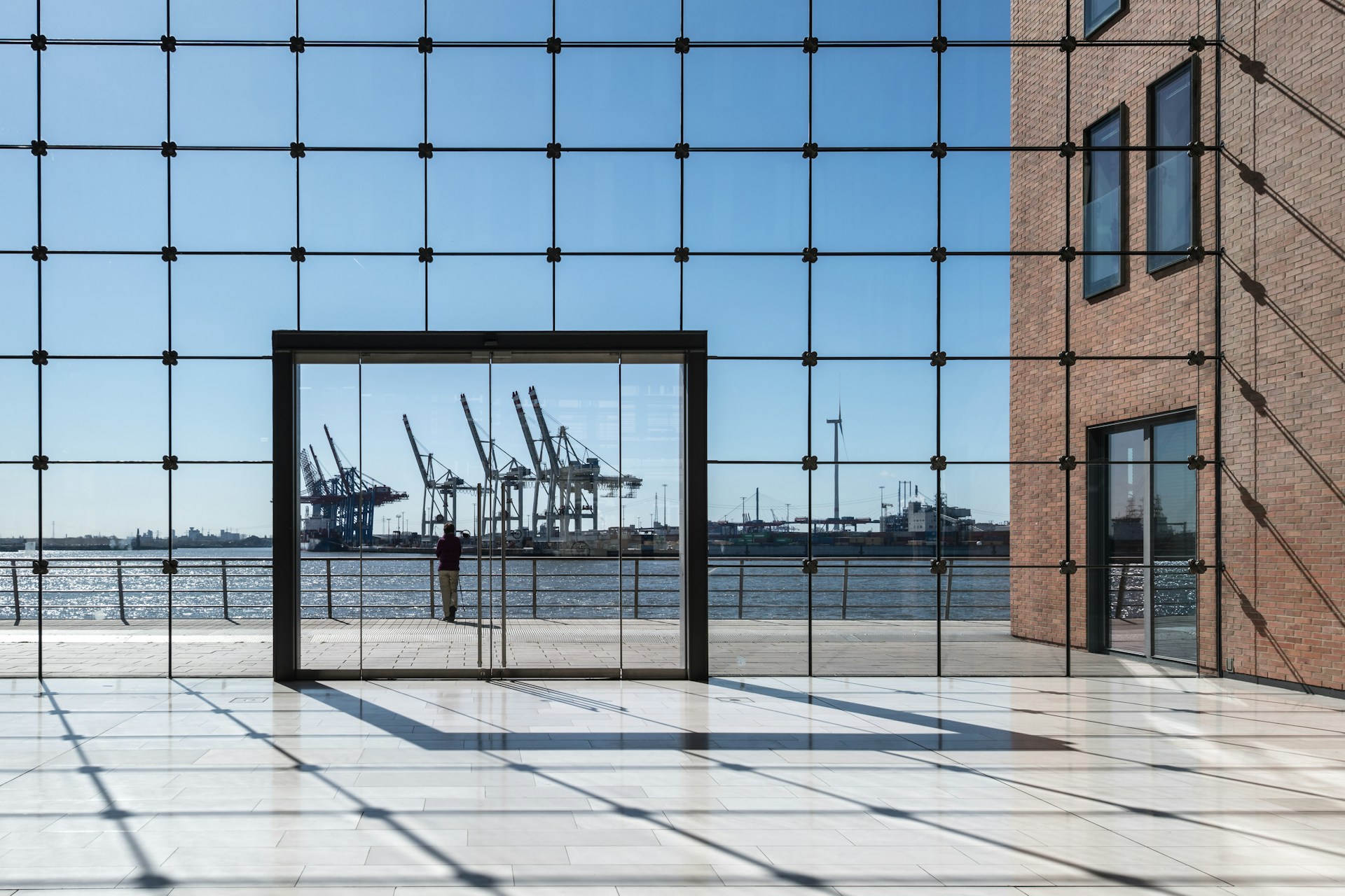 Photo by <a href="https://unsplash.com/@hamburgmeinefreundin?utm_source=unsplash&utm_medium=referral&utm_content=creditCopyText">Wolfgang Weiser</a> on <a href="https://unsplash.com/photos/modern-building-overlooking-a-harbor-with-cranes-PEHev_Xo_hM?utm_source=unsplash&utm_medium=referral&utm_content=creditCopyText">Unsplash</a>